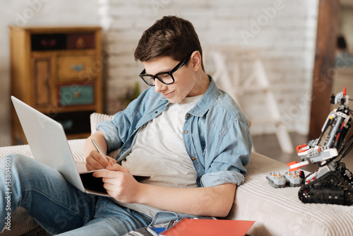 Diligent teenager writing down some tasks