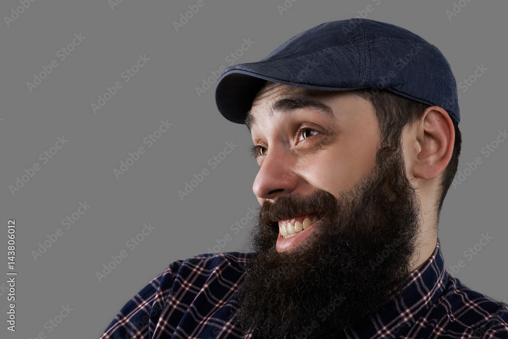 Happy and crazy close up bearded male face. Man surprised of little prices on goods. Week of sale concept. Guy have funny smile isolated on grey background. Copy space for advertising text Happy and crazy close up bearded male face. Man surprised of little prices on goods. Week of sale concept. Guy have funny smile isolated on grey background. Copy space for advertising text