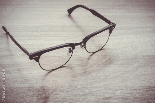Eyeglasses Glasses with Black Frame Fashion Vintage Style on Wood Desk Background