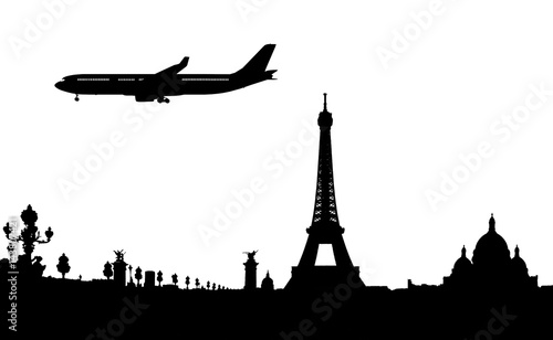 silhouette of paris and plane landing