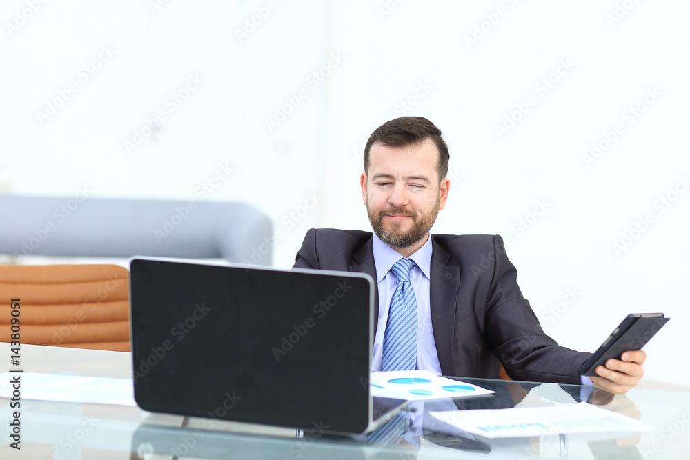 Business man using laptop and modern devices in office Business man using laptop and modern devices in office