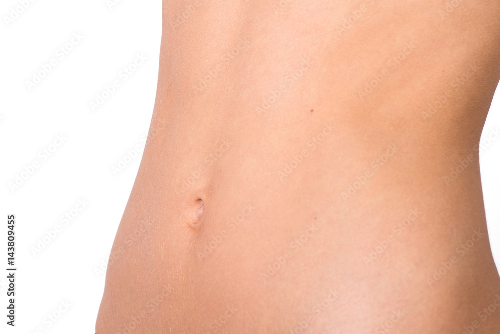 Athletic women belly on beige background. Front view. Close-up