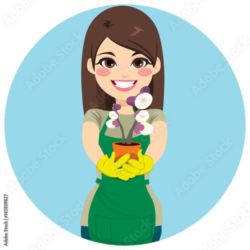Beautiful gardener woman showing and holding flowerpot