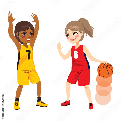 Two young female girls playing on basketball match
