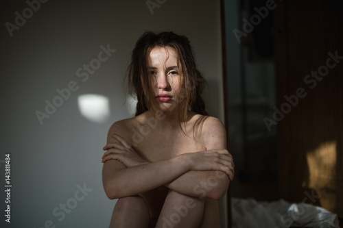 Naked woman feeling vulnerable