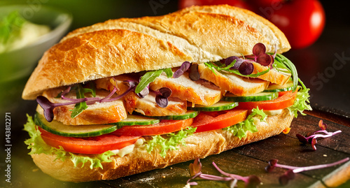 Delicious fresh chicken baguette with salad