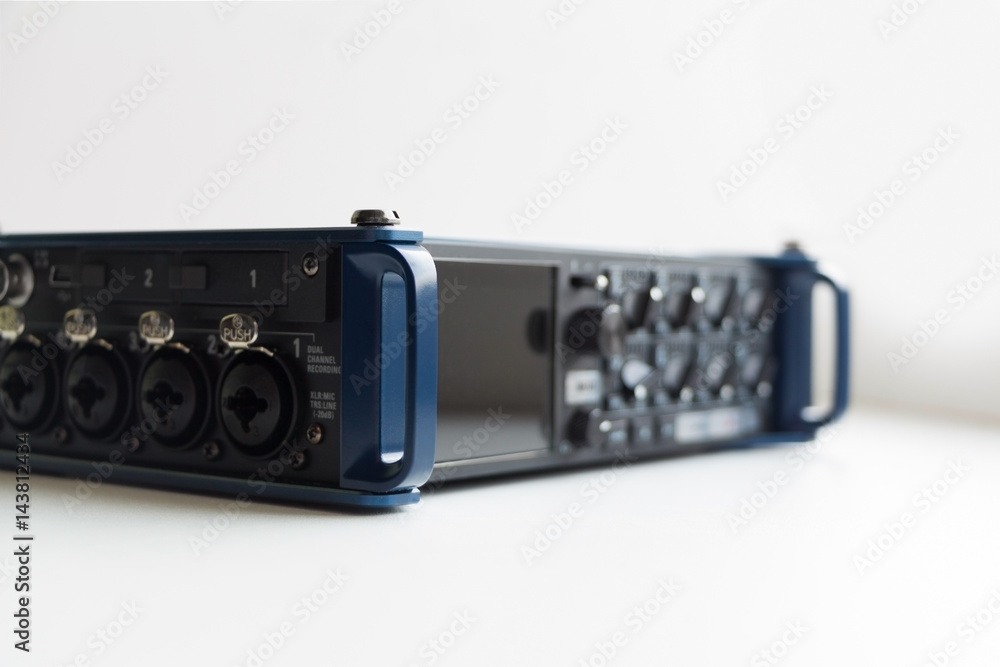 Obraz premium Professional audio recorder with connectors and knobs. Selective focus