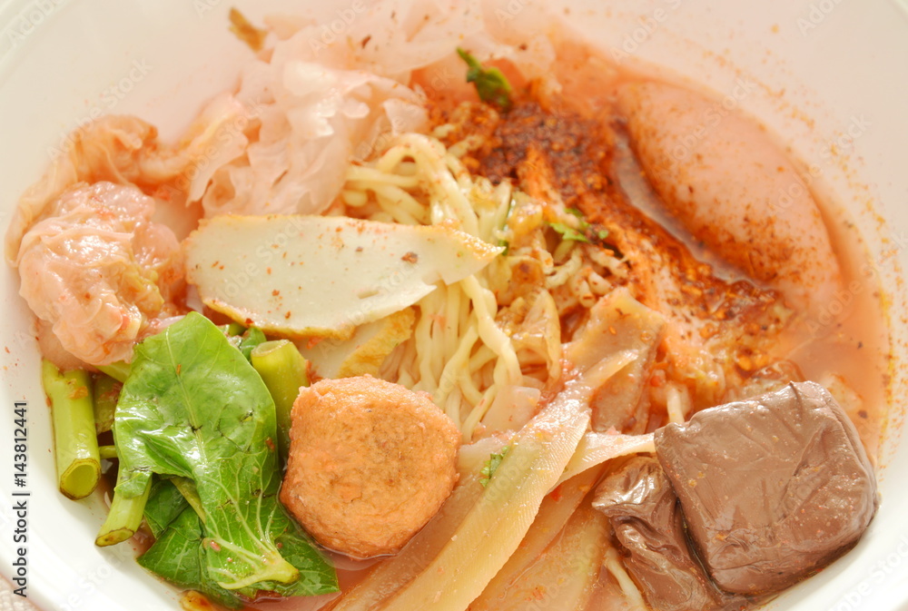 Chinese egg noodles with shrimp and fish ball in red soup Chinese