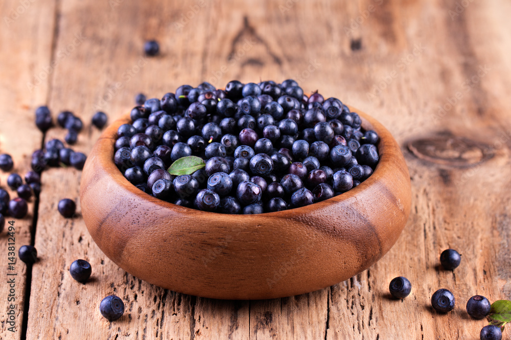 Blueberries in a bowl on a wooden table. Blueberries in a bowl on a wooden table.