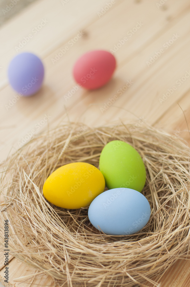 Easter eggs in nest on wood background Easter eggs in nest on wood background