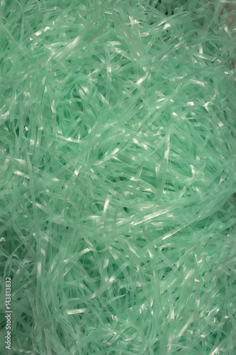 This is a photograph of Turquoise shredded plastic fake Easter grass background