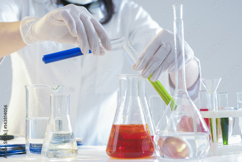 Research and Science Concepts. Closeup of Hands of Female Laboratory Staff Working With Liquids Specimens in Flasks in Laboratory During Experiment. Research and Science Concepts. Closeup of Hands of Female Laboratory Staff Working With Liquids Specimens in Flasks in Laboratory During Experiment.