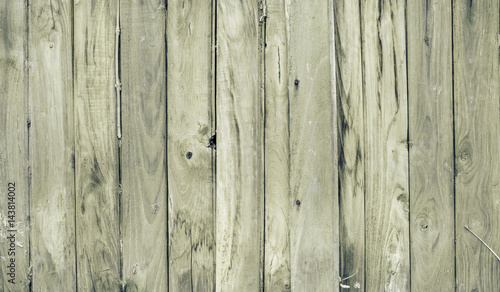 Vertical wooden fence close up. Natural look wood plank background or texture. Vintage filter.