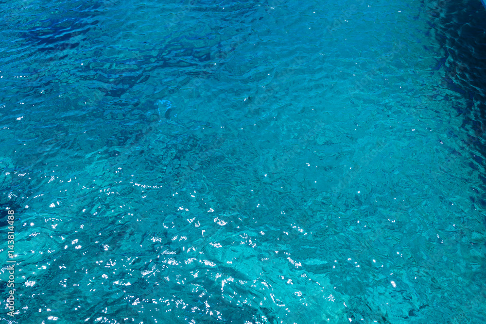 Shining blue water ripple background. Clear sea water background. Photo from Zakynthos Island, Greece.