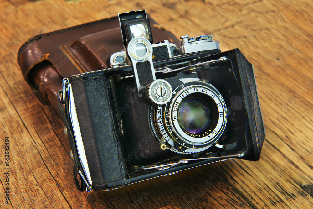  Old camera on a wooden background. Set of photographer