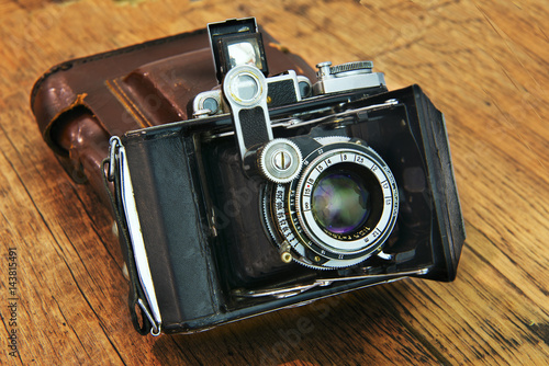  Old camera on a wooden background. Set of photographer