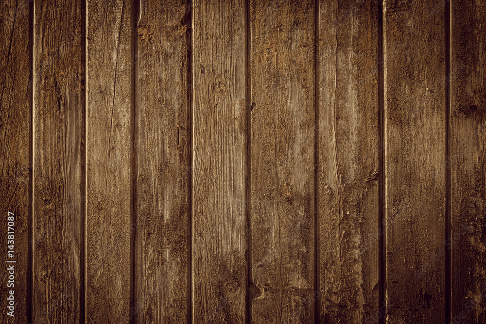 Obraz premium Old rural wooden wall in warm brown colors, detailed plank photo texture. Natural wooden building structure background.
