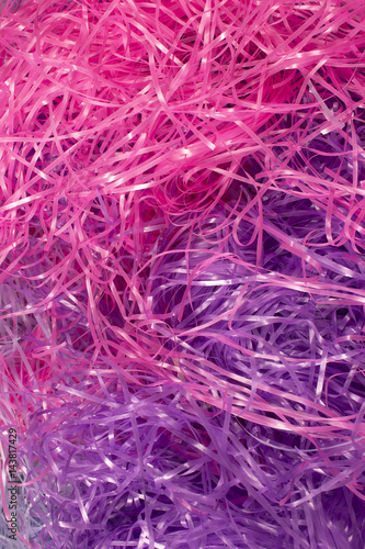 This is a photograph of Pink and Purple shredded plastic fake Easter grass background