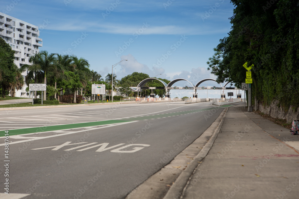 Fototapeta premium Bicycle lane signage on street for special bicycle road on Rickenbacker causeway for Key Biscayne. Near the ocean and Virginia Key. Miami. Florida. USA. Miami neighborhood.