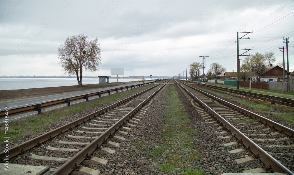 Fototapeta premium the railroad at the dam in the future on a cloudy day