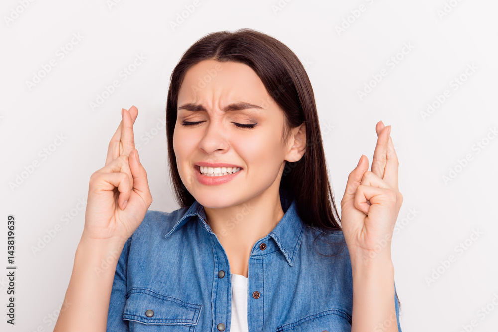 Portrait of young pretty woman with crossed fingers and closed eyes waiting for luck. Minded girl hoping for the best Portrait of young pretty woman with crossed fingers and closed eyes waiting for luck. Minded girl hoping for the best
