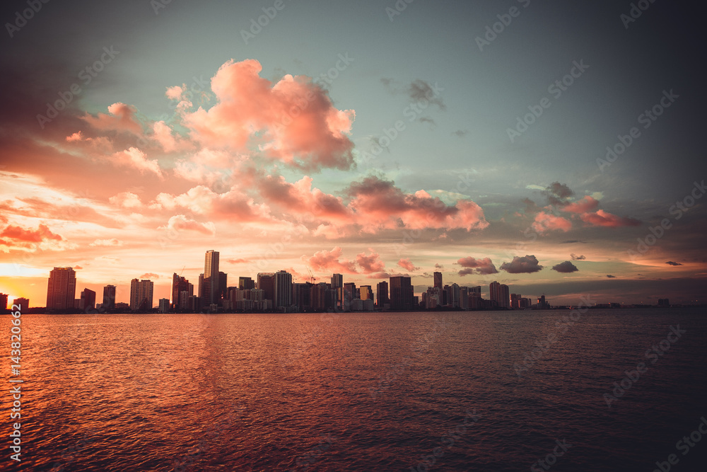 Miami Florida sunset over downtown business and luxury residential buildings, hotels and illuminated bridge over Biscayne Bay. Cityscape of World famous travel destination. Florida. USA