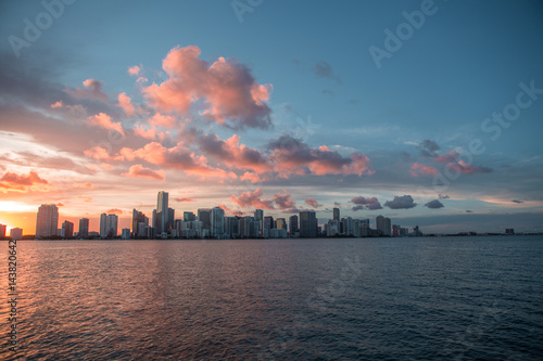 Miami Florida sunset over downtown business and luxury residential buildings, hotels and illuminated bridge over Biscayne Bay. Cityscape of World famous travel destination. Florida. USA
