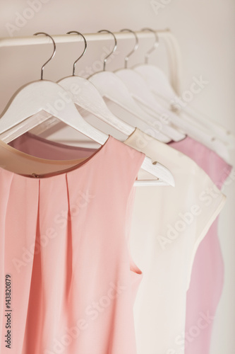 Women's clothing in pink tones on a white hanger.