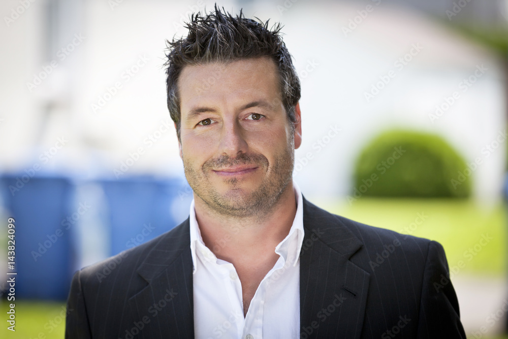 Mature Businessman Smiling At The Camera. He is outside of the office Mature Businessman Smiling At The Camera. He is outside of the office