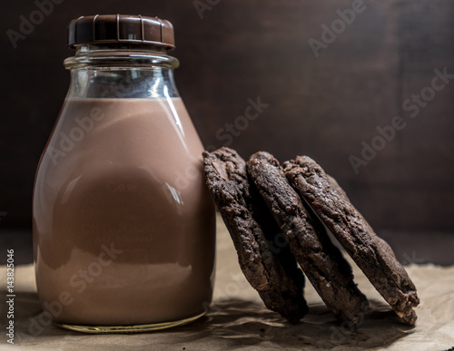 Vászonkép Double Chocolate Cookies Leaning Against Chocolate Milk