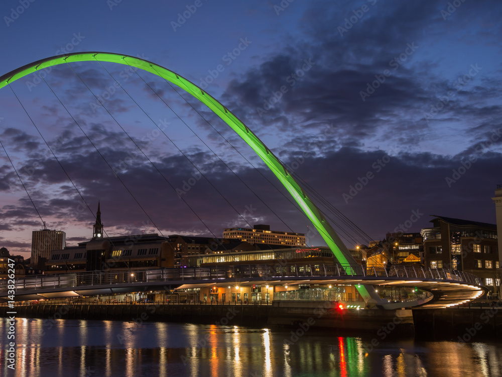 Newcastle upon Tyne, England, United Kingdom. The Gateshead Millennium Bridge and its colors during evening time