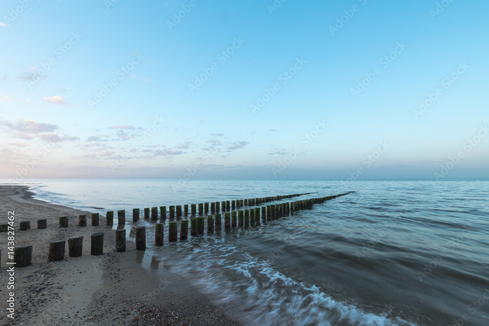 Timber Piles In The Morning At Renesse Zeeland / Netherland