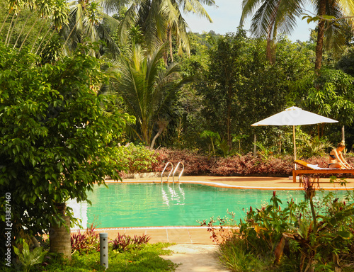 open air swimming pool in tropical jungle photo