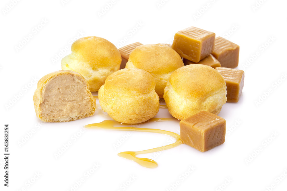 Carmel Cream Puffs with Carmels Pieces and Sauce on White Background Carmel Cream Puffs with Carmels Pieces and Sauce on White Background