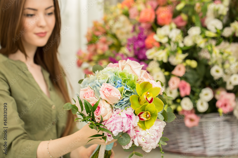Beautiful female florist at her flower shop
