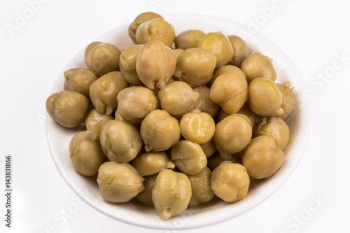 Bowl of preserved chickpeas isolated on white background