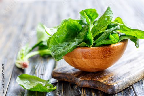 Fresh spinach in a wooden bowl.