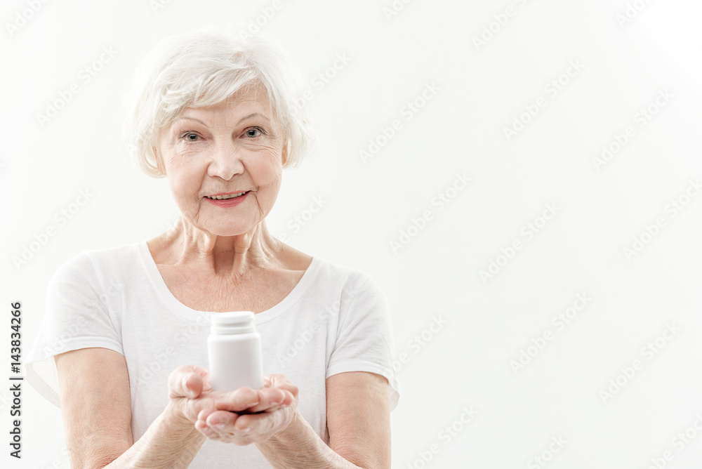 Happy old lady advising to take pills