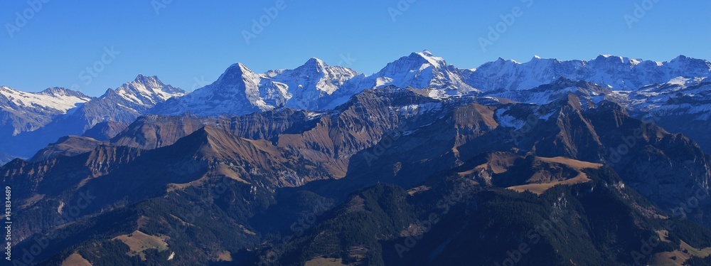 Famous mountains Eiger, Monch and Jungfrau. View from mount Niesen. Autumn day in the Bernese Oberland.