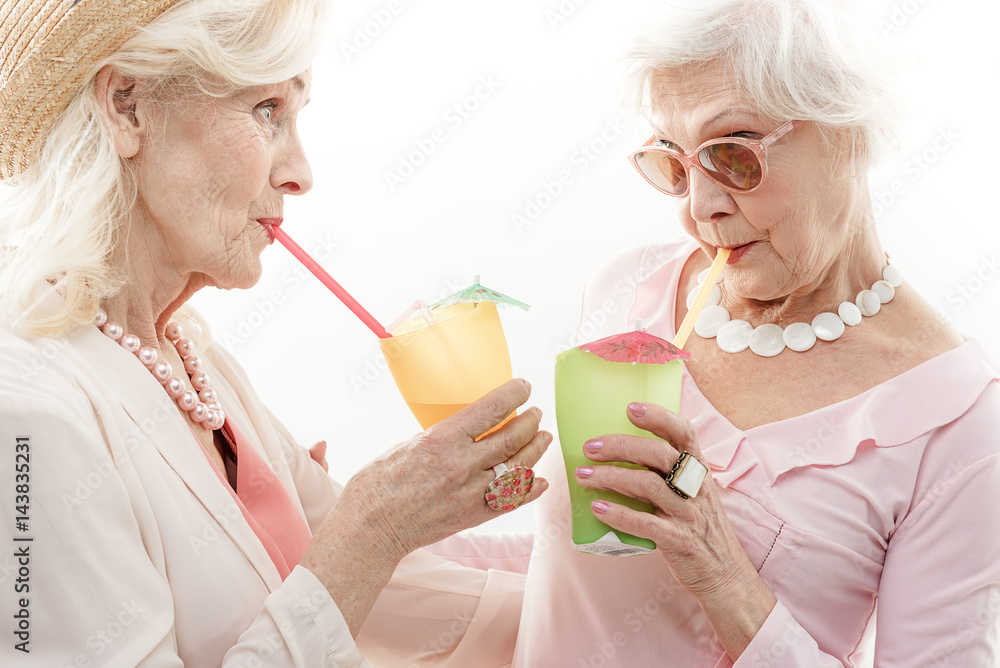 Old women tasting alcohol beverage Old women tasting alcohol beverage