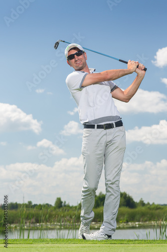 Professional male golfer playing