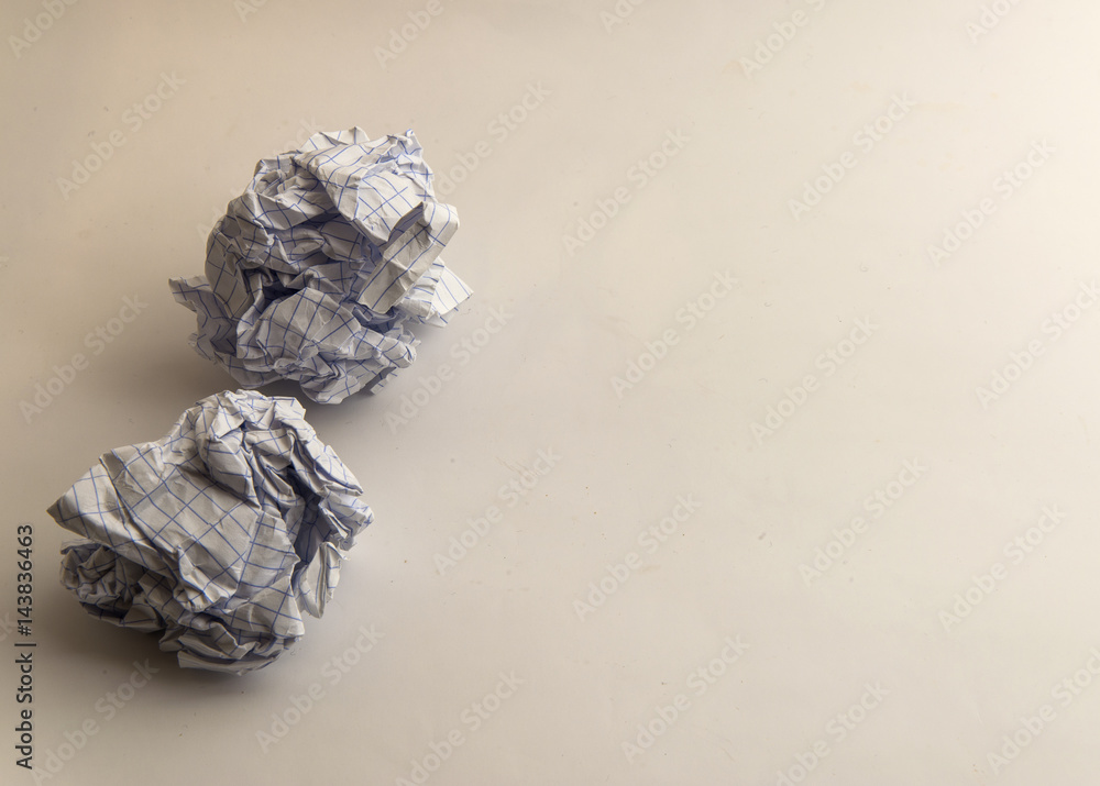Two grey lined Crumpled paper Balls on yellow