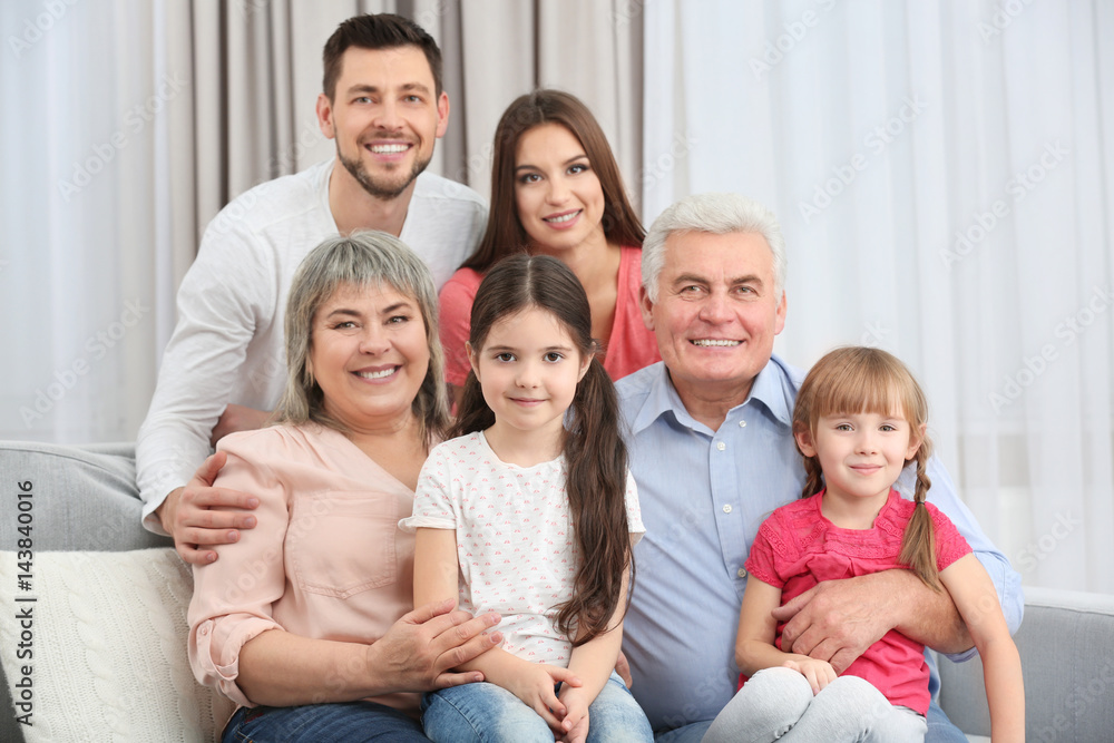 Happy family sitting on sofa in the room