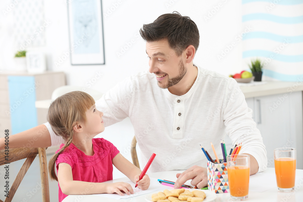 Young man and little girl drawing at kitchen table Young man and little girl drawing at kitchen table