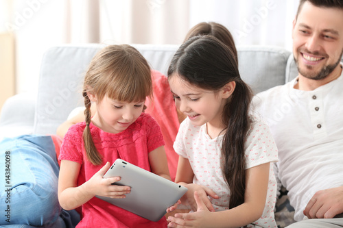 Little girls with tablet at...