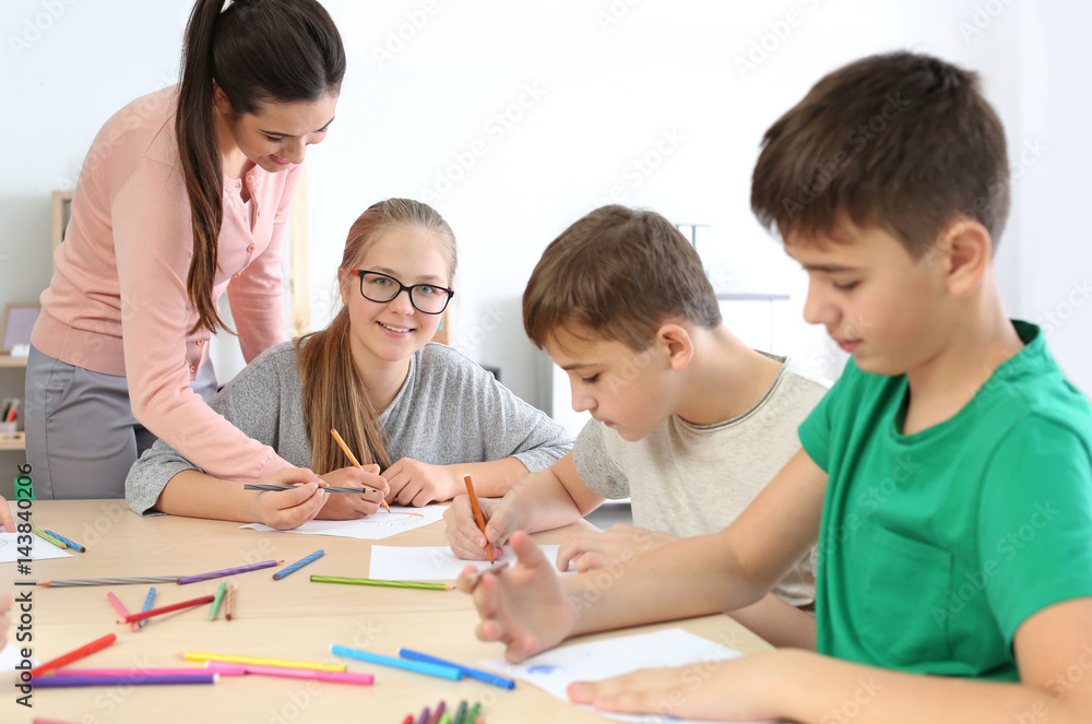 Female teacher conducting lesson in classroom
