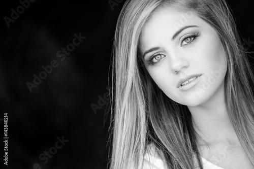 Senior photo of a young woman on a farm wearing farm style clothing