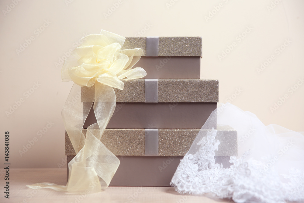 Fototapeta premium Table with gift boxes and veil for wedding day