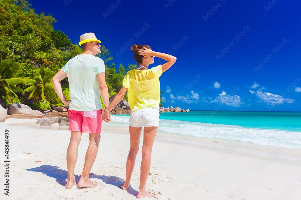 happy young couple having fun by the beach happy young couple having fun by the beach