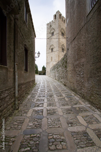 Fototapeta Naklejka Na Ścianę i Meble -  Erice cathedral bell tower: view from a typical alley of this unique middle age country